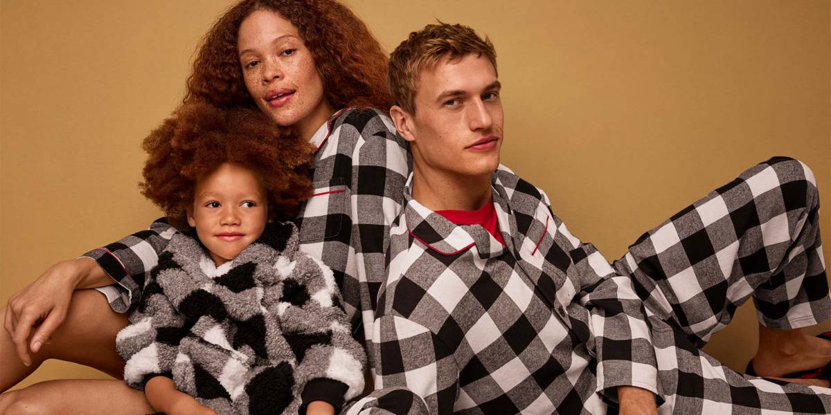 Family wearing matching check PJs. Shop Christmas nightwear 